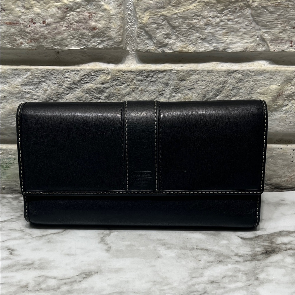 Coach Hampton smooth black leather trifold wallet with white contrast stitching.